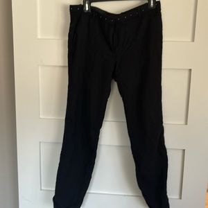 The couples size 42, black dress pants with studs along the belt.